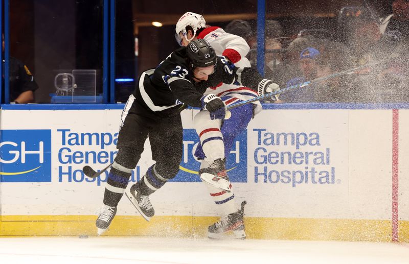 Mar 2, 2024; Tampa, Florida, USA;  dTampa Bay Lightning center Michael Eyssimont (23) checks Montreal Canadiens right wing Josh Anderson (17) during the second period at Amalie Arena. Mandatory Credit: Kim Klement Neitzel-USA TODAY Sports