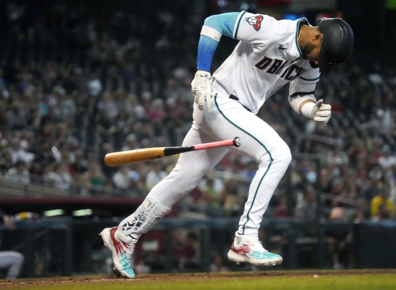 Jun 29, 2023; Phoenix, Arizona, USA; Arizona Diamondbacks left fielder Lourdes Gurriel Jr. (12) reacts to hitting into a double play against the Tampa Bay Rays at Chase Field. Mandatory Credit: Joe Rondone-USA TODAY Sports