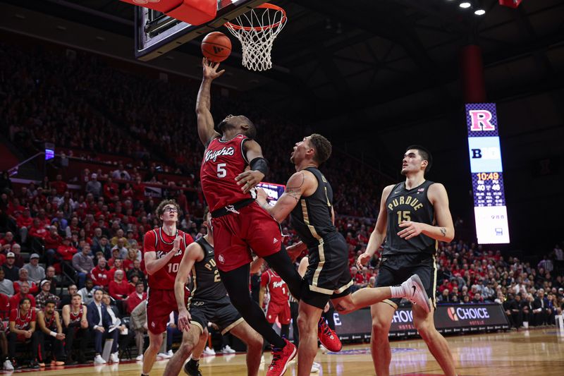 Jan 28, 2024; Piscataway, New Jersey, USA; Rutgers Scarlet Knights forward Aundre Hyatt (5) scores a basket as Purdue Boilermakers forward Mason Gillis (0) defends \in front of center Zach Edey (15) during the second half at Jersey Mike's Arena. Mandatory Credit: Vincent Carchietta-USA TODAY Sports