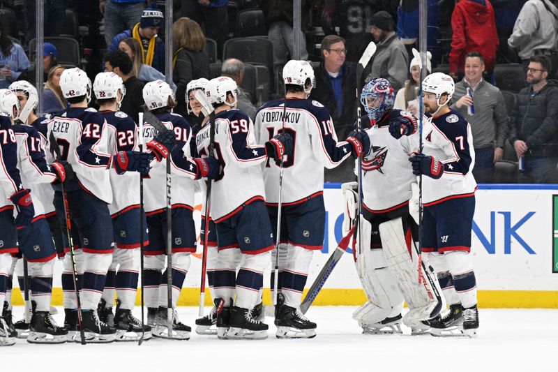 Jan 30, 2024; St. Louis, Missouri, USA; Columbus Blue Jackets goaltender Elvis Merzlikins (90) is congratulated by teammates after a shutout victory over the St. Louis Blues at Enterprise Center. Mandatory Credit: Jeff Le-USA TODAY Sports