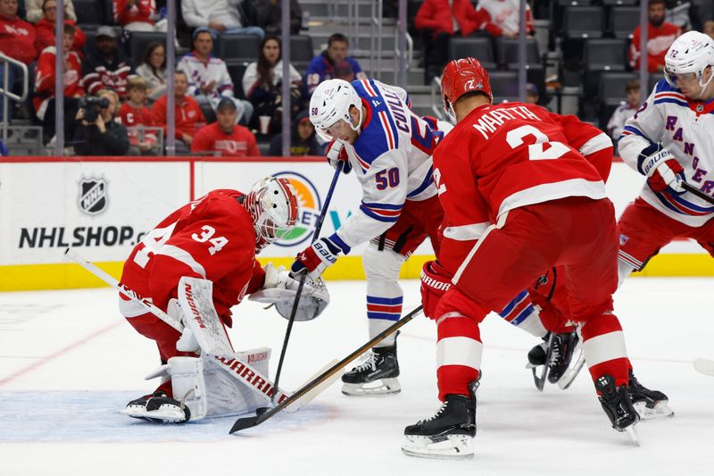 Oct 17, 2024; Detroit, Michigan, USA;  Detroit Red Wings goaltender Alex Lyon (34) makes a save on New York Rangers left wing Will Cuylle (50) in the third period at Little Caesars Arena. Mandatory Credit: Rick Osentoski-Imagn Images