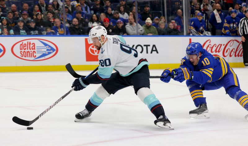 Jan 9, 2024; Buffalo, New York, USA;  Seattle Kraken left wing Tomas Tatar (90) looks to take a shot on goal as Buffalo Sabres defenseman Henri Jokiharju (10) tries to defend during the first period at KeyBank Center. Mandatory Credit: Timothy T. Ludwig-USA TODAY Sports