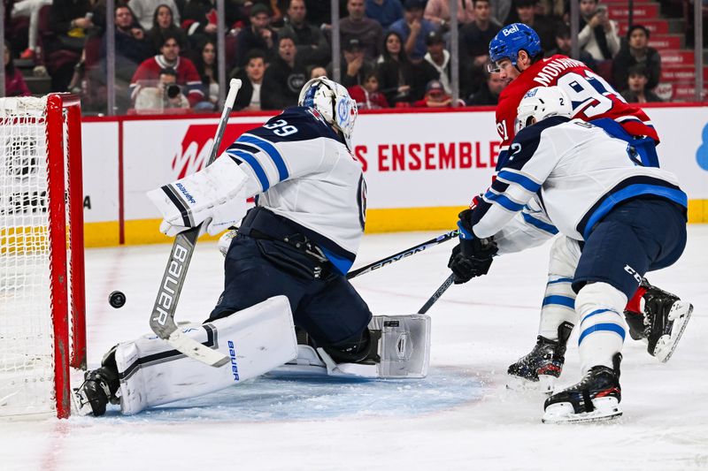 Oct 28, 2023; Montreal, Quebec, CAN; Winnipeg Jets goalie Laurent Brossoit (39) gives a goal to Montreal Canadiens center Sean Monahan (91) during the second period at Bell Centre. Mandatory Credit: David Kirouac-USA TODAY Sports