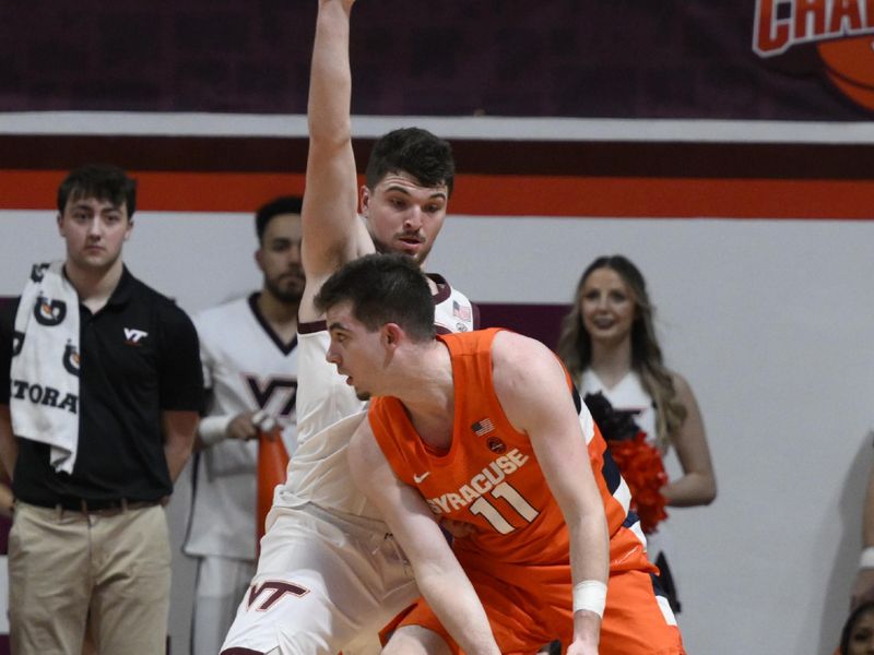 Jan 28, 2023; Blacksburg, Virginia, USA;  Virginia Tech Hokies guard Hunter Cattoor (0) defends against Syracuse Orange guard Joseph Girard III (11) in the second halfat Cassell Coliseum. Mandatory Credit: Lee Luther Jr.-USA TODAY Sports