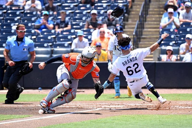 May 21, 2025; St. Petersburg, Florida, USA; Houston Astros catcher Yainer Diaz (21) waits for the ball as Tampa Bay Rays first baseman Jonathan Aranda (62) scores a run in the first inning at George M. Steinbrenner Field. Mandatory Credit: Jonathan Dyer-Imagn Images