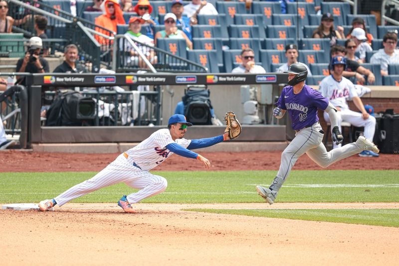 Jul 14, 2024; New York City, New York, USA; New York Mets third baseman Mark Vientos (27) can not hold the bag as Colorado Rockies right fielder Hunter Goodman (15) reaches first base safely on a fielders choice during the fifth inning at Citi Field. Mandatory Credit: Vincent Carchietta-USA TODAY Sports