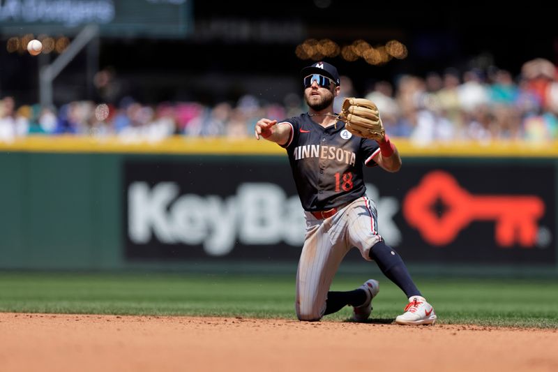 Jun 1, 2025; Seattle, Washington, USA; Minnesota Twins second baseman Kody Clemens (18) throws Minnesota Twins shortstop Carlos Correa (4) out at first during the fifth inning at T-Mobile Park. Mandatory Credit: John Froschauer-Imagn Images