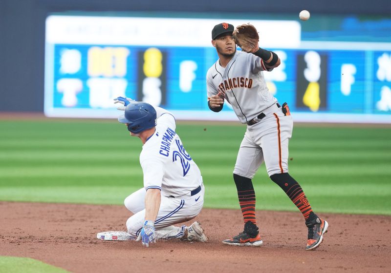 Jun 29, 2023; Toronto, Ontario, CAN; Toronto Blue Jays third baseman Matt Chapman (26) gets on second base on a throwing error against the San Francisco Giants during the second inning at Rogers Centre. Mandatory Credit: Nick Turchiaro-USA TODAY Sports