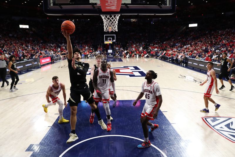 Feb 18, 2023; Tucson, Arizona, USA; Colorado Buffaloes guard KJ Simpson (2) makes a basket against Arizona Wildcats guard Pelle Larsson (3), center Oumar Ballo (11), and guard Cedric Henderson Jr. (45) during the second half at McKale Center. Mandatory Credit: Zachary BonDurant-USA TODAY Sports