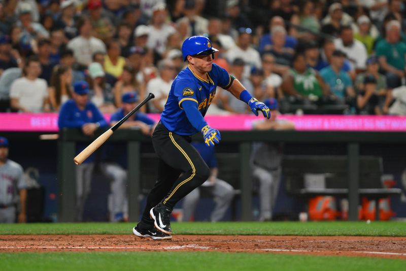 Aug 9, 2024; Seattle, Washington, USA; Seattle Mariners third baseman Dylan Moore (25) runs towards first base after hitting a single against the New York Mets during the seventh inning at T-Mobile Park. Mandatory Credit: Steven Bisig-USA TODAY Sports