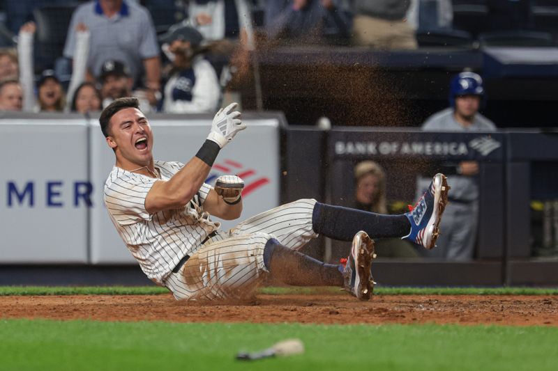 Sep 11, 2024; Bronx, New York, USA; New York Yankees shortstop Anthony Volpe (11) reacts after scoring a run on a sacrifice fly by catcher Austin Wells (not pictured) during the tenth inning against the Kansas City Royals at Yankee Stadium. Mandatory Credit: Vincent Carchietta-Imagn Images