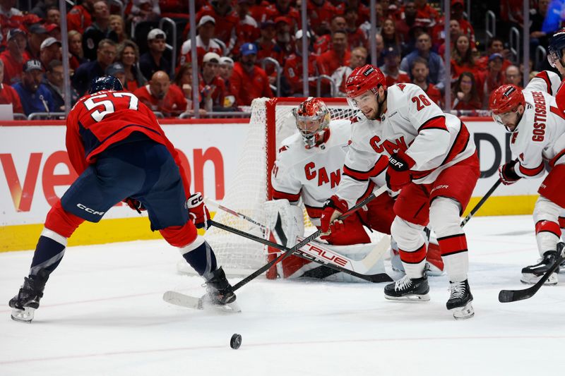 May 8, 2025; Washington, District of Columbia, USA; Carolina Hurricanes defenseman Sean Walker (26) clears the puck from in front of Hurricanes goaltender Frederik Andersen (31) as Washington Capitals defenseman Trevor van Riemsdyk (57) reaches in the first period in game two of the second round of the 2025 Stanley Cup Playoffs at Capital One Arena. Mandatory Credit: Geoff Burke-Imagn Images