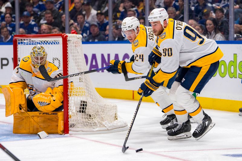 Apr 23, 2024; Vancouver, British Columbia, CAN; Nashville Predators goalie Juuse Saros (74) and defenseman Spencer Stastney (24) watch as forward Ryan O'Reilly (90) handles the puck against the Vancouver Canucks during the third period in game two of the first round of the 2024 Stanley Cup Playoffs at Rogers Arena. Mandatory Credit: Bob Frid-USA TODAY Sports