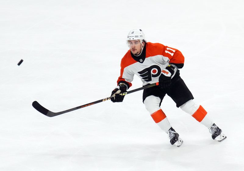 Dec 7, 2023; Tempe, Arizona, USA; Philadelphia Flyers right wing Travis Konecny (11) skates after a loose puck against the Arizona Coyotes during the third period at Mullett Arena. Mandatory Credit: Joe Camporeale-USA TODAY Sports