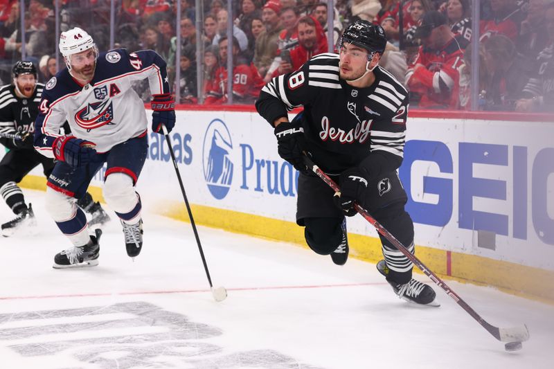 Feb 3, 2026; Newark, New Jersey, USA; New Jersey Devils right wing Timo Meier (28) skates with the puck as Columbus Blue Jackets defenseman Erik Gudbranson (44) defends during the second period at Prudential Center. Mandatory Credit: Ed Mulholland-Imagn Images