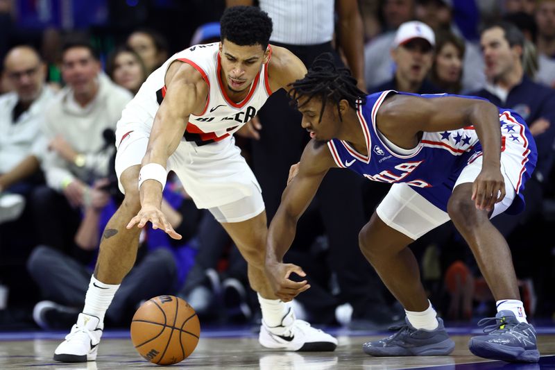 PHILADELPHIA, PENNSYLVANIA - OCTOBER 29: Toumani Camara #33 of the Portland Trail Blazers and Tyrese Maxey #0 of the Philadelphia 76ers challenge for a loose ball during the fourth quarter at Wells Fargo Center on October 29, 2023 in Philadelphia, Pennsylvania. NOTE TO USER: User expressly acknowledges and agrees that, by downloading and or using this photograph, User is consenting to the terms and conditions of the Getty Images License Agreement. (Photo by Tim Nwachukwu/Getty Images)