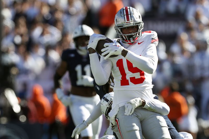 Nov 2, 2024; University Park, Pennsylvania, USA; Ohio State Buckeyes tight end Jelani Thurman (15) makes a catch on fourth down during the second quarter against the Penn State Nittany Lions at Beaver Stadium. Mandatory Credit: Matthew O'Haren-Imagn Images