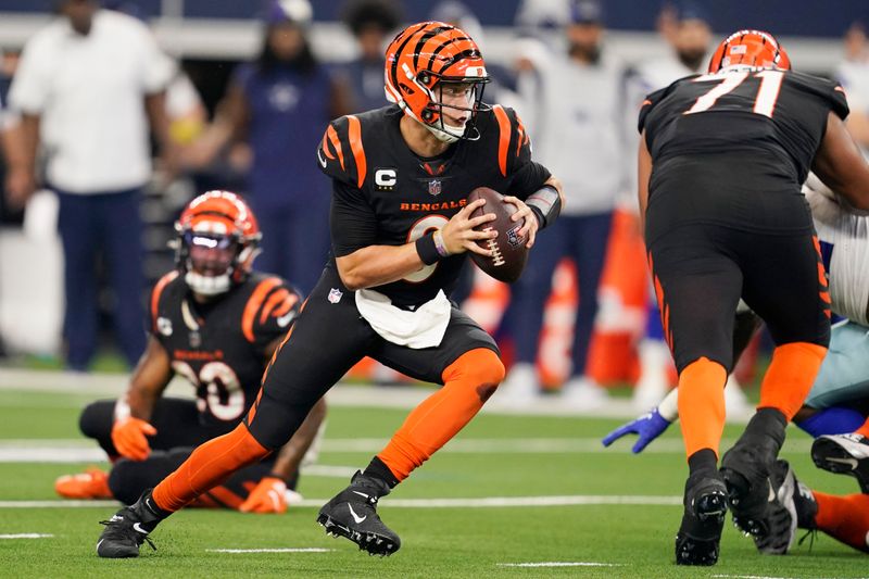 Cincinnati Bengals quarterback Joe Burrow (9) scrambles during the second half of an NFL football game against the Dallas Cowboys Sunday, Sept. 18, 2022, in Arlington, Tx. (AP Photo/Tony Gutierrez)