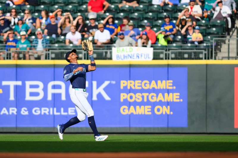 Jun 13, 2024; Seattle, Washington, USA; Seattle Mariners center fielder Julio Rodriguez (44) catches a fly ball during the first inning against the Chicago White Sox at T-Mobile Park. Mandatory Credit: Steven Bisig-USA TODAY Sports