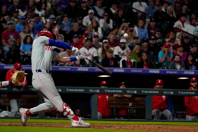 May 25, 2024; Denver, Colorado, USA;  Philadelphia Phillies first base Bryce Harper (3) hits a three-run homer in the ninth inning at Coors Field. The Philadelphia Phillies defeated the Colorado Rockies 8-4. Mandatory Credit: Michael Madrid-USA TODAY Sports