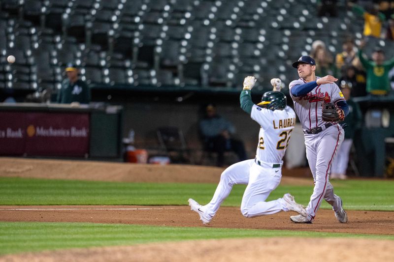 May 30, 2023; Oakland, California, USA;  Atlanta Braves third baseman Austin Riley (27) throws home not in time for Oakland Athletics right fielder Seth Brown (not pictured) to score the game winning run during the ninth inning at Oakland-Alameda County Coliseum. Mandatory Credit: Neville E. Guard-USA TODAY Sports