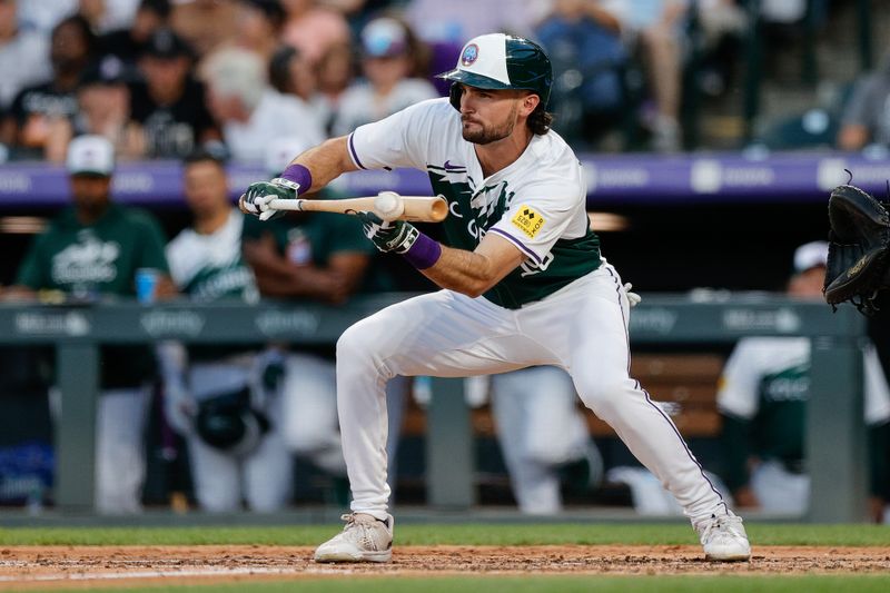 Jul 6, 2024; Denver, Colorado, USA; Colorado Rockies left fielder Sam Hilliard (16) bunts in the fifth inning against the Kansas City Royals at Coors Field. Mandatory Credit: Isaiah J. Downing-USA TODAY Sports