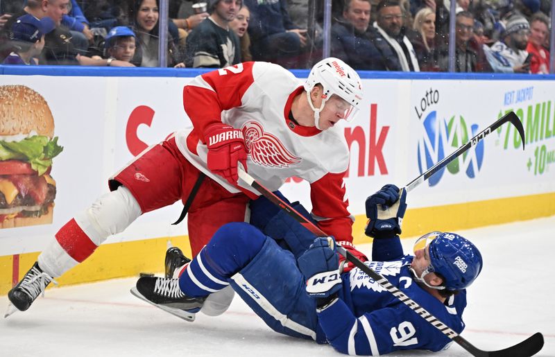 Jan 14, 2024; Toronto, Ontario, CAN;  Detroit Red Wings defenseman Olli Maatta (2) knocks down Toronto Maple Leafs forward John Tavares (91) in the first period at Scotiabank Arena. Mandatory Credit: Dan Hamilton-USA TODAY Sports