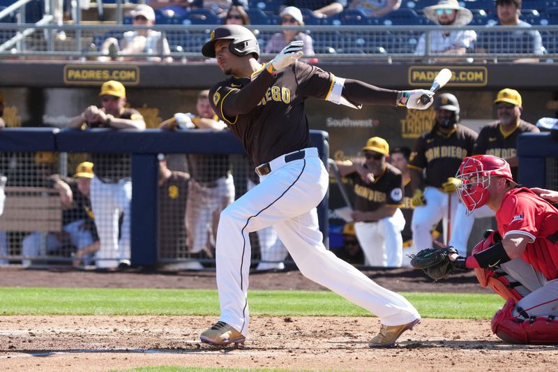 Feb 25, 2025; Peoria, Arizona, USA; San Diego Padres third base Manny Machado (13) bats against the Los Angeles Angels during the fourth inning at Peoria Sports Complex. Mandatory Credit: Rick Scuteri-Imagn Images