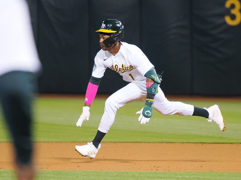 Apr 28, 2023; Oakland, California, USA; Oakland Athletics center fielder Esteury Ruiz (1) dives for second base on a fielding error by the Cincinnati Reds during the seventh inning at Oakland Coliseum. Mandatory Credit: Kelley L Cox-USA TODAY Sports