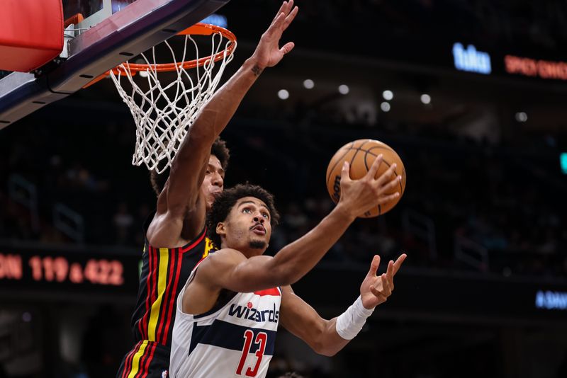 WASHINGTON, DC - OCTOBER 30: Jordan Poole #13 of the Washington Wizards shoots the ball against Jalen Johnson #1 of the Atlanta Hawks during the first half at Capital One Arena on October 30, 2024 in Washington, DC. NOTE TO USER: User expressly acknowledges and agrees that, by downloading and or using this photograph, User is consenting to the terms and conditions of the Getty Images License Agreement. (Photo by Scott Taetsch/Getty Images)