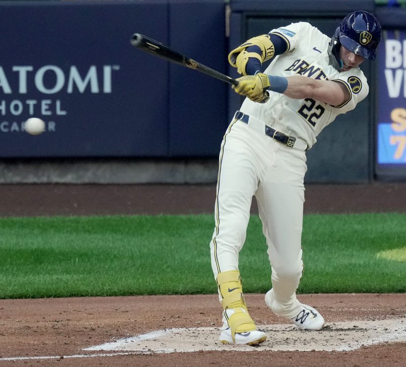 Jul 10, 2024; Milwaukee, Wisconsin, USA; Milwaukee Brewers outfielder Christian Yelich (22) hits a single during the third inning against the Pittsburgh Pirates at American Family Field in Milwaukee, Wisconsin.  Mandatory Credit: Mark Hoffman-USA TODAY Sports