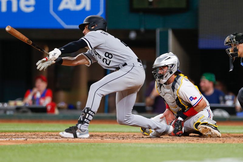 Aug 2, 2023; Arlington, Texas, USA; Texas Rangers catcher Austin Hedges (11) blocks a pitch as Chicago White Sox second baseman Zach Remillard (28) reaches for a pitch down in the dirt during the eighth inning at Globe Life Field. Mandatory Credit: Andrew Dieb-USA TODAY Sports