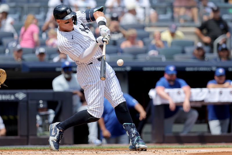 Aug 3, 2024; Bronx, New York, USA; New York Yankees designated hitter Aaron Judge (99) hits a two run home run against the Toronto Blue Jays during the first inning at Yankee Stadium. Mandatory Credit: Brad Penner-USA TODAY Sports