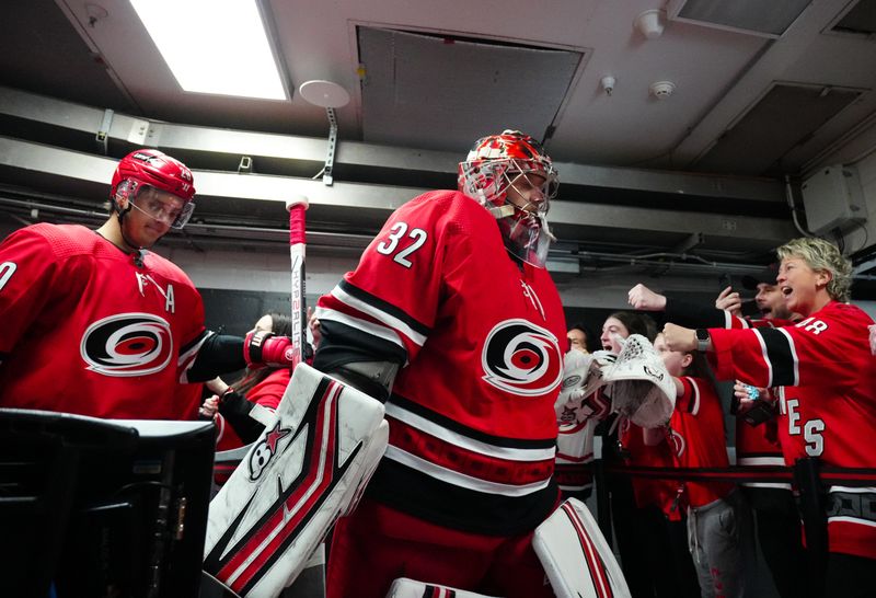 Dec 28, 2023; Raleigh, North Carolina, USA; Carolina Hurricanes goaltender Antti Raanta (32) goes past the fans before the start of the game against the Montreal Canadiens at PNC Arena. Mandatory Credit: James Guillory-USA TODAY Sports