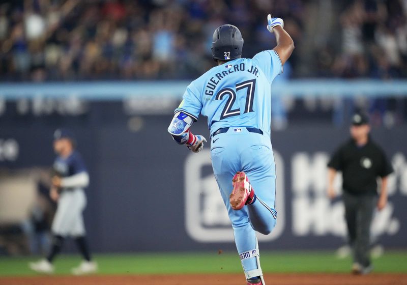 Jul 23, 2024; Toronto, Ontario, CAN; Toronto Blue Jays first base Vladimir Guerrero Jr. (27) runs the bases after hitting a home run against the Tampa Bay Rays during the sixth inning at Rogers Centre. Mandatory Credit: Nick Turchiaro-USA TODAY Sports