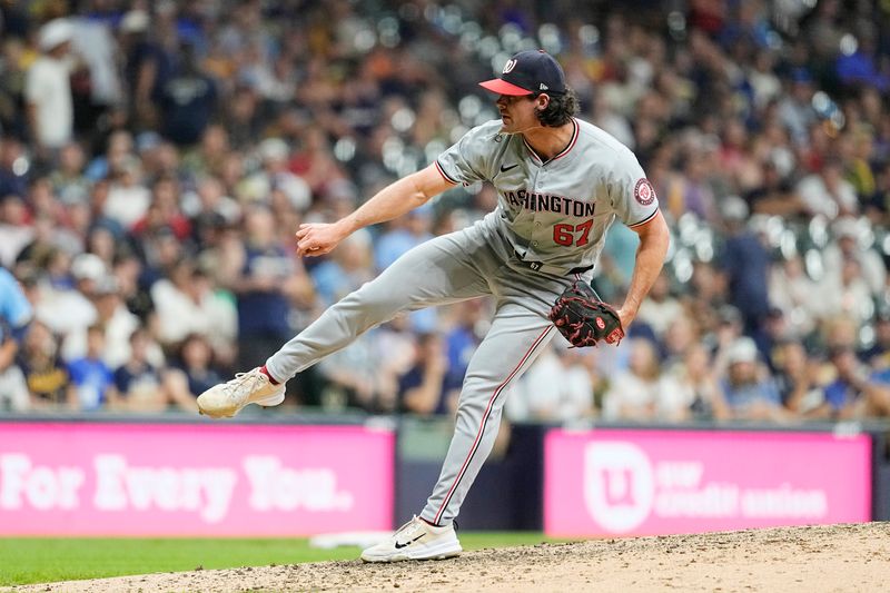 Jul 12, 2024; Milwaukee, Wisconsin, USA;  Washington Nationals pitcher Kyle Finnegan (67) throws a pitch during the ninth inning against the Milwaukee Brewers at American Family Field. Mandatory Credit: Jeff Hanisch-USA TODAY Sports