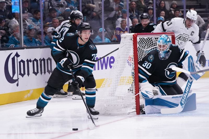 Oct 28, 2025; San Jose, California, USA; LSan Jose Sharks left wing William Eklund (72) controls the puck as San Jose Sharks goaltender Yaroslav Askarov (30) guards the net against the Los Angeles Kings in the first period at SAP Center at San Jose. Mandatory Credit: David Gonzales-Imagn Images