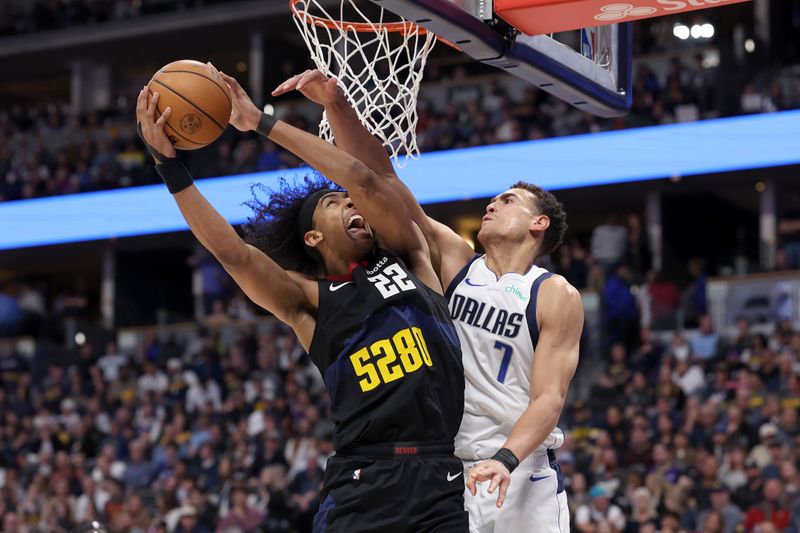 DENVER, COLORADO - DECEMBER 18: Zeke Nnaji #22 of the Denver Nuggets goes to the basket against Dwight Powell #7 of the Dallas Mavericks in the fourth quarter at Ball Arena on December 18, 2023 in Denver, Colorado. NOTE TO USER: User expressly acknowledges and agrees that, by downloading and or using this photograph, User is consenting to the terms and conditions of the Getty Images License Agreement.   (Photo by Matthew Stockman/Getty Images)