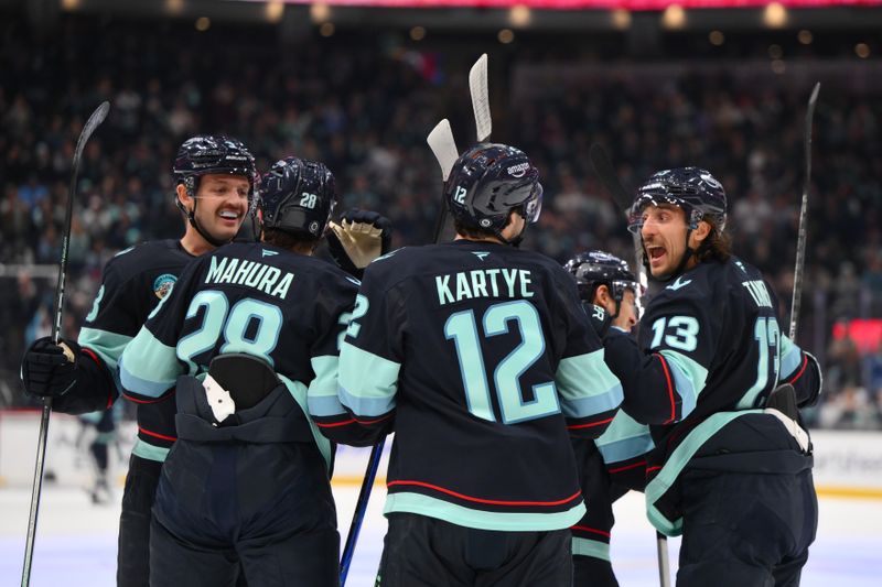 Nov 16, 2024; Seattle, Washington, USA; The Seattle Kraken celebrate after a goal scored by center Yanni Gourde (37) (not pictured) during the first period against the New York Islanders at Climate Pledge Arena. Mandatory Credit: Steven Bisig-Imagn Images