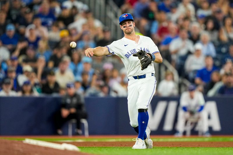 Jun 29, 2024; Toronto, Ontario, CAN; Toronto Blue Jays third base Ernie Clement (28) throws to first base against the New York Yankees at Rogers Centre. Mandatory Credit: Kevin Sousa-USA TODAY Sports