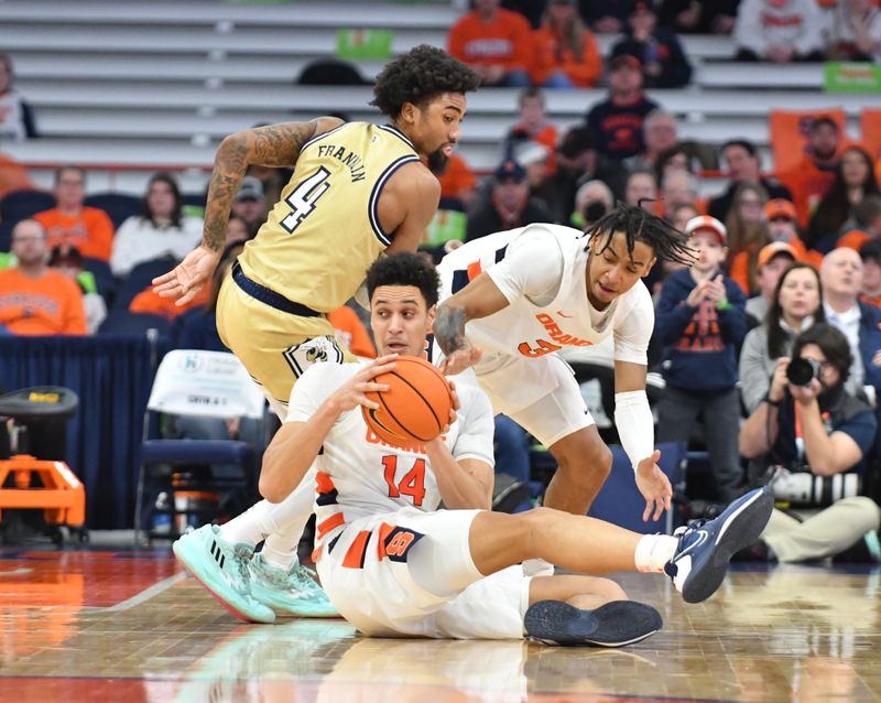 Feb 28, 2023; Syracuse, New York, USA; Syracuse Orange center Jesse Edwards (14) grabs a loose ball as guard Judah Mintz (3) and Georgia Tech Yellow Jackets forward Javon Franklin (4) look on in the second half at the JMA Wireless Dome. Mandatory Credit: Mark Konezny-USA TODAY Sports