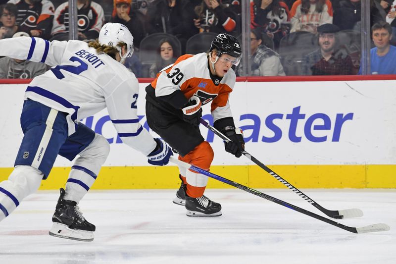 Jan 7, 2025; Philadelphia, Pennsylvania, USA; Philadelphia Flyers right wing Matvei Michkov (39) drives to the net against Toronto Maple Leafs defenseman Simon Benoit (2) during the first period at Wells Fargo Center. Mandatory Credit: Eric Hartline-Imagn Images