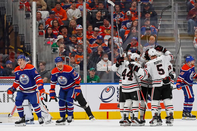 Oct 12, 2024; Edmonton, Alberta, CAN; The Chicago Blackhawks celebrate a goal scored by  forward Philipp Kurashev (23) during the first period against the Edmonton Oilers at Rogers Place. Mandatory Credit: Perry Nelson-Imagn Images