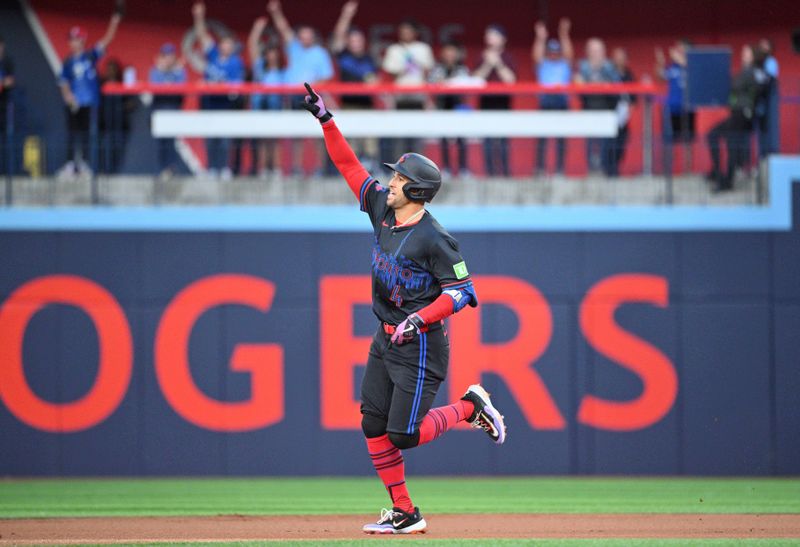 Aug 21, 2024; Toronto, Ontario, CAN;  Toronto Blue Jays designated hitter George Springer (4) celebrates as he rounds the bases after hitting a solo home run against the Cincinnati Reds in the first inning at Rogers Centre. Mandatory Credit: Dan Hamilton-USA TODAY Sports