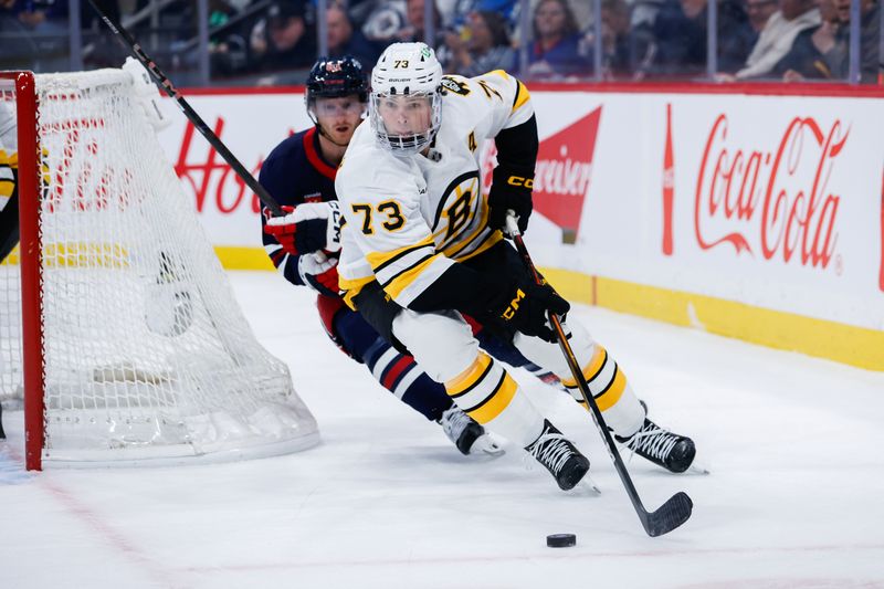 Dec 11, 2025; Winnipeg, Manitoba, CAN; Boston Bruins defenseman Charlie McAvoy (73) skates away from Winnipeg Jets forward Kyle Connor (81) during the second period at Canada Life Centre.  Mandatory Credit: Terrence Lee-Imagn Images