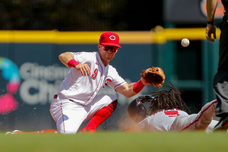 Aug 6, 2023; Cincinnati, Ohio, USA; Cincinnati Reds second baseman Matt McLain (9) attempts to tag Washington Nationals shortstop CJ Abrams (5) out at second in the sixth inning at Great American Ball Park. Mandatory Credit: Katie Stratman-USA TODAY Sports