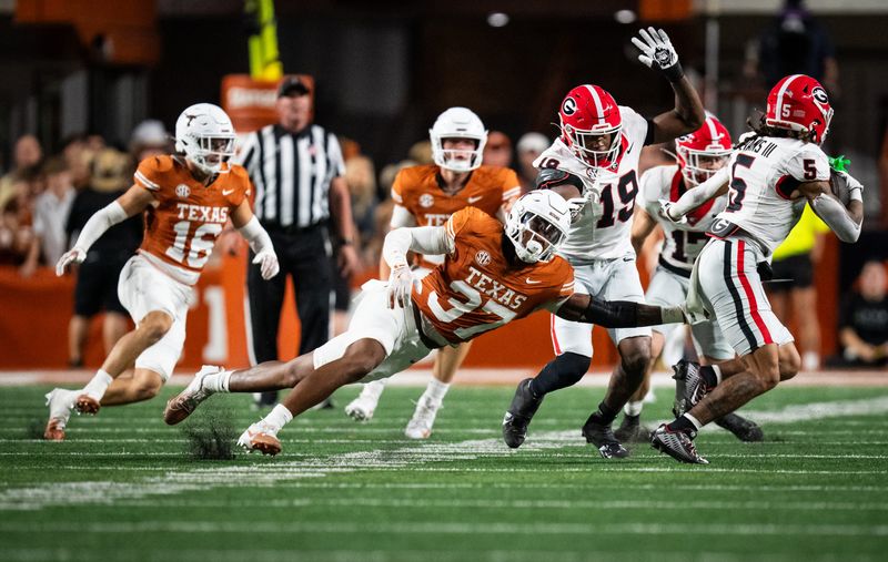 Oct 19, 2024; Austin, Texas, USA; Texas Longhorns linebacker Morice Blackwell Jr. (37) reaches to tackle Georgia Bulldogs wide receiver Anthony Evans III (5) in the second quarter at Darrell K. Royal Texas Memorial Stadium. Mandatory Credit: Sara Diggins/USA TODAY Network via Imagn Images