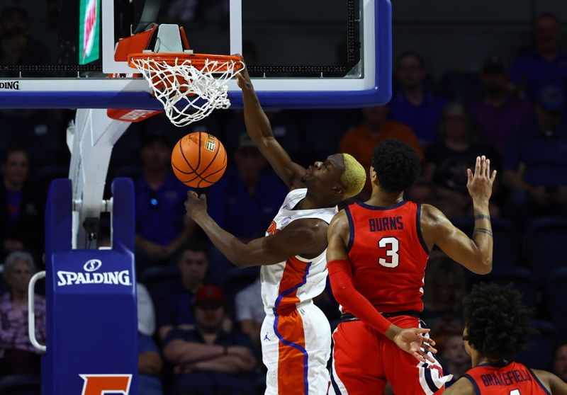 Feb 15, 2023; Gainesville, Florida, USA; Florida Gators guard Kowacie Reeves (14) dunks over Mississippi Rebels forward Myles Burns (3) during the first half at Exactech Arena at the Stephen C. O'Connell Center. Mandatory Credit: Kim Klement-USA TODAY Sports