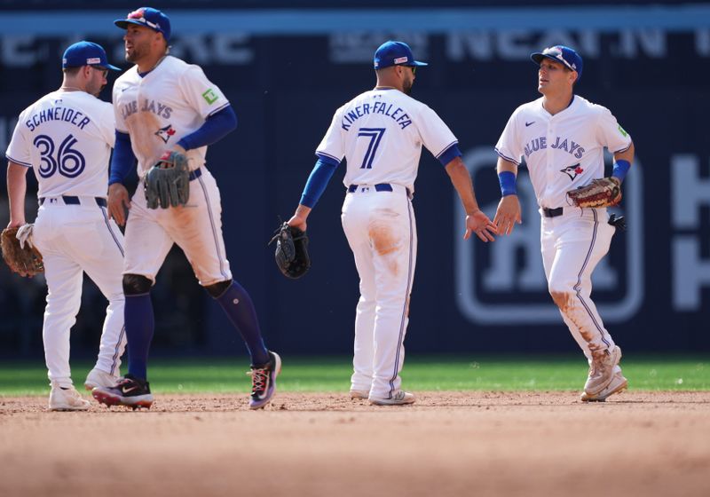 Jun 15, 2024; Toronto, Ontario, CAN; Toronto Blue Jays shortstop Isiah Kiner-Falefa (7) celebrates the win with left fielder Daulton Varsho (25) at the end of the ninth inning after a game against the Cleveland Guardians at Rogers Centre. Mandatory Credit: Nick Turchiaro-USA TODAY Sports