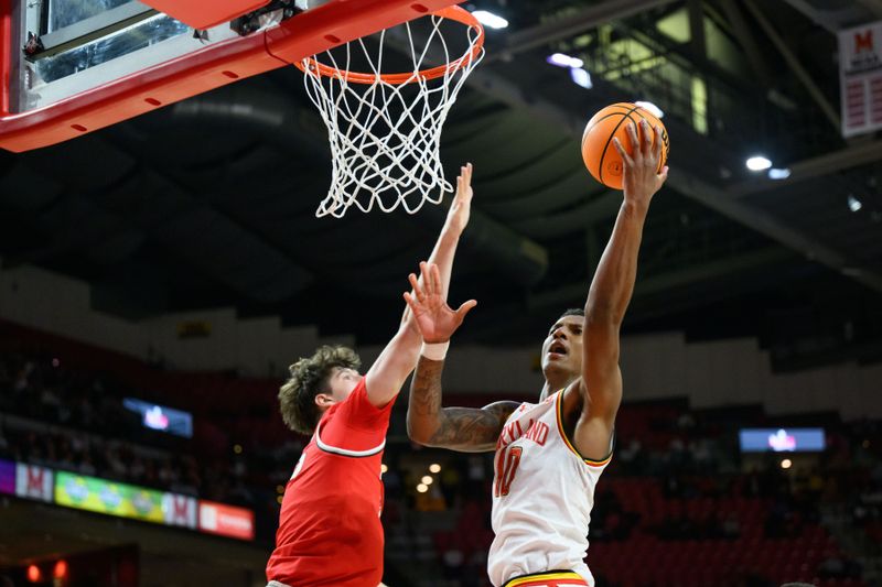 Dec 4, 2024; College Park, Maryland, USA; Maryland Terrapins forward Julian Reese (10) takes a shot over Ohio State Buckeyes center Austin Parks (25) during the second half at Xfinity Center. Mandatory Credit: Reggie Hildred-Imagn Images